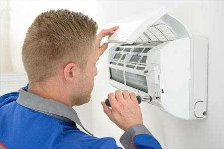 Certified technician repairing a Mini-Split A/C
